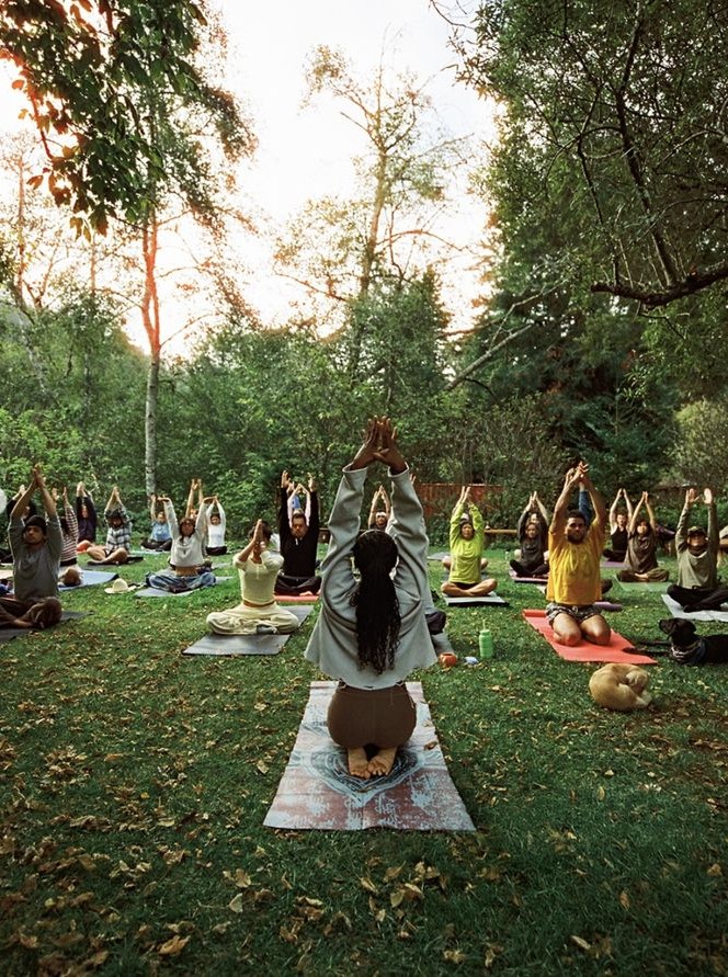 Yoga teacher leading an outdoor class